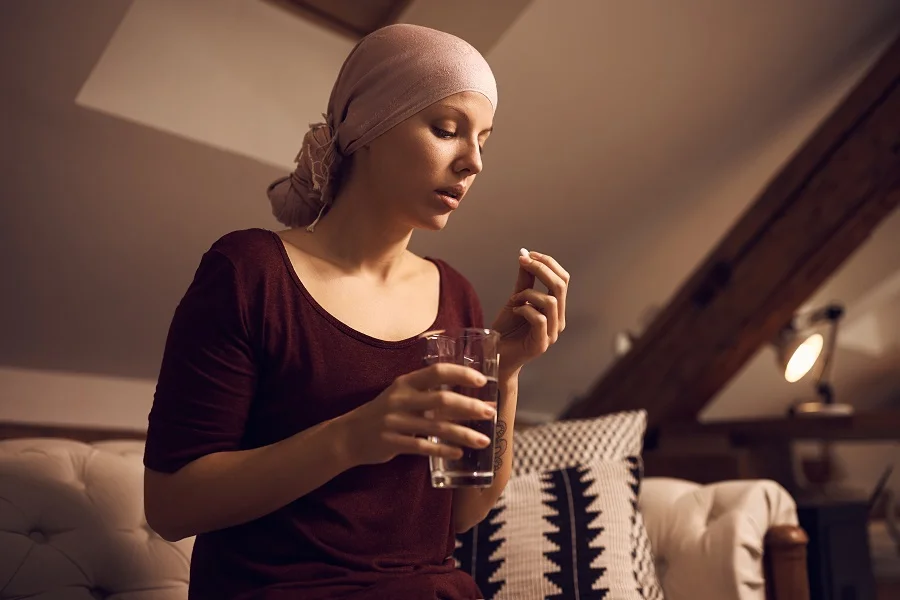Bald cancer patient taking supplements